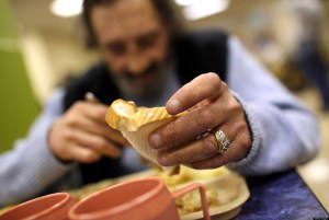SAN FRANCISCO - SEPTEMBER 16: A man named R.J. holds a piece of bread as he eats a free meal provided by St. Anthony foundation on September 16, 2010 in San Francisco, California. The U.S. poverty rate increased to a 14.3 percent in 2009, the highest level since 1994. St. Anthony Foundation serves an average of 2,600 meals a day to homeless and impoverished people in San Francisco. (Photo by Justin Sullivan/Getty Images)